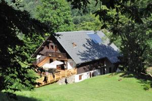 a house with a solar roof on a hill at La Grange Aux Loups in Queige