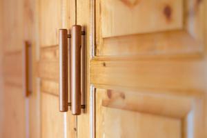 a close up of wooden cabinets with wooden doors at Nashos Bungalows in (( Spile ))