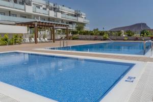 a large swimming pool in front of a building at TEJITA BEACH APARTMENT in El Médano