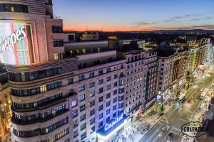 a view of a city at night with a building at Charming Gran Vía Callao in Madrid