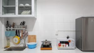 a kitchen with a counter top with a microwave at Chic Studio Homestay in Hue