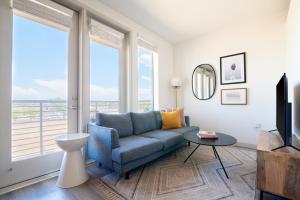 a living room with a couch and a large window at Sonder at Hance Park in Phoenix