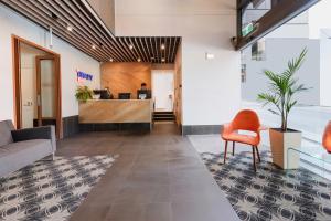 an office lobby with a chair and a desk at Brady Hotels Central Melbourne in Melbourne