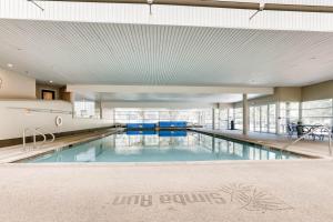 a large swimming pool with blue water in a building at Simba Run Vail Condominiums in Vail