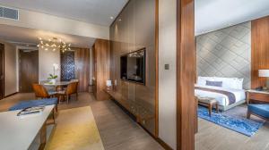 a hotel room with a bed and a table at Hard Rock Hotel Desaru Coast in Desaru