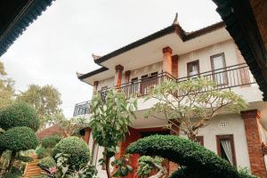 a house with a balcony on top of it at HOKYY Accommodation in Ubud