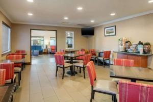 a dining room with red chairs and tables at Comfort Inn Columbia Gorge in The Dalles