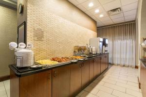 a kitchen with a table and a tray of food at Clarion Hotel Convention Center in Minot