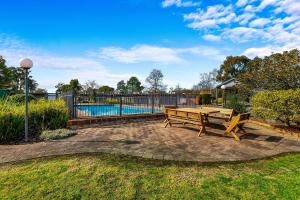 a patio with a picnic table and a pool at Quality Inn & Suites Traralgon in Traralgon