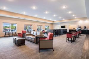 a lobby with a waiting room with chairs and tables at Comfort Suites Marysville Columbus - Northwest in Marysville +49 photos