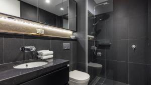 a bathroom with a sink and a toilet and a shower at Avani Melbourne Box Hill Residences in Box Hill