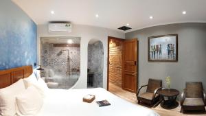 a bedroom with a bed and a shower and a bathroom at Saigon1984 Vintage Private Home Central District 1 with 6 bedrooms and 6 bathrooms in Ho Chi Minh City