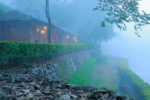 a foggy street next to a house in the fog at Saj Vagamon Hideout in Vagamon