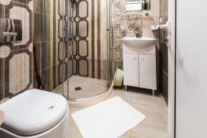 a bathroom with a toilet and a sink at Guest House Theona in Obzor