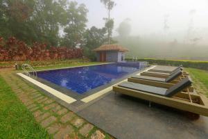 a swimming pool with a gazebo in a yard at Saj Vagamon Hideout in Vagamon