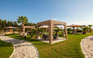 a gazebo with tables and chairs in a park at Hotel Nour Congress & Resort in Bizerte