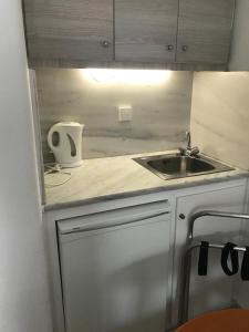 a small kitchen with a sink and a counter at Romantika in Platis Gialos