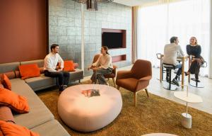 a group of people sitting in a living room at Aparthotel Adagio Muenchen City in Munich