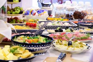 Hotel Rezydencja في كارباش: بوفيه مليء بأواني الطعام على طاولة