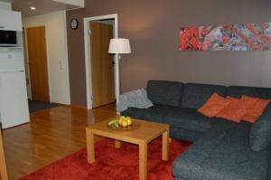 a living room with a blue couch and a table at Ruka Chalets 1201 in Ruka