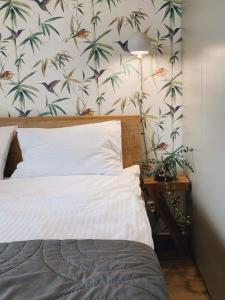 a bedroom with a bed and a wall with palm trees at Olympic Residence in Szczyrk