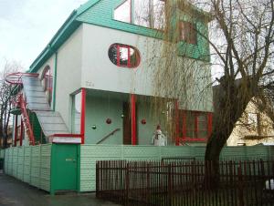 a house with a dog in the window of it at Guest House LT in Kaunas