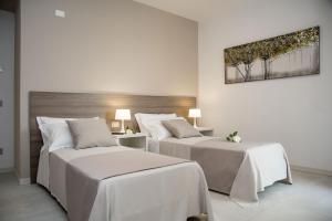 Posteľ alebo postele v izbe v ubytovaní Camelot Appartamenti - Business e Holiday