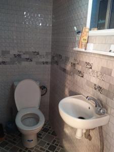 a bathroom with a toilet and a sink at The call of nature in Tafedna +12 photos