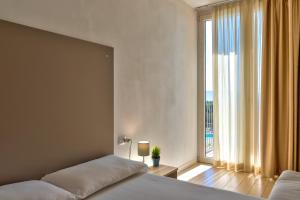 A bed or beds in a room at La Chioma di Berenice Garda Residence