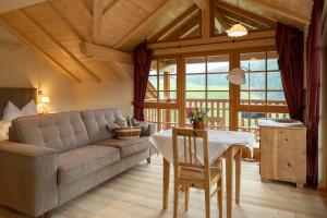 a living room with a couch and a table at Villa Messner in Funes