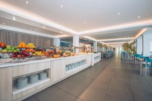 a buffet line with fruits and vegetables on display at Iberostar Waves Herceg Novi All Inclusive in Herceg-Novi