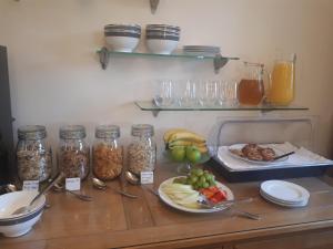 a counter with jars and plates of food on it at Berry House Bed & Breakfast in Littlehampton