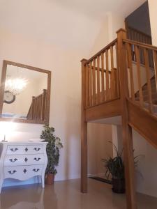 a staircase in a room with a dresser and a mirror at Berry House Bed & Breakfast in Littlehampton