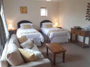 a living room with two beds and a couch at Berry House Bed & Breakfast in Littlehampton
