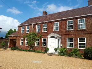 a red brick house with a white door at Berry House Bed & Breakfast in Littlehampton