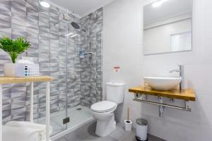 a bathroom with a shower and a toilet and a sink at Sleep Inn Lagos - Rooms in Lagos