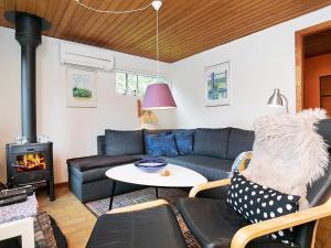 a living room with a couch and a fireplace at 4 person holiday home in Gedser in Gedser
