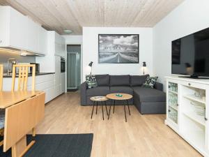 a living room with a couch and a table at 4 person holiday home in R m in Rømø Kirkeby