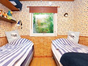 two beds in a room with a window at 4 person holiday home in Gedser in Gedser