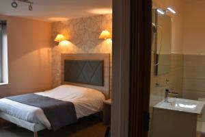 Postel nebo postele na pokoji v ubytování LOGIS Hotel Restaurant Auberge Du Cheval Blanc
