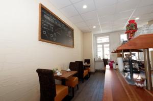 a restaurant with a dining room with a chalkboard on the wall at PrivatHotel Probst in Nürnberg