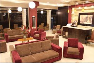 a lobby with couches and chairs and a bar at Alexander Hotel in Bethlehem