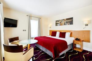 a hotel room with a bed with a red blanket at Arlington Hotel O'Connell Bridge in Dublin