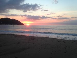 a sunset on a beach near the ocean at Stones Hotel and Bar in Minehead