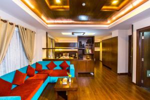 a living room with a blue couch and a table at Kathmandu Suite Home in Kathmandu