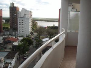 a balcony of a building with a view of a city at DORREGO 17 BIS in Rosario