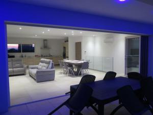 a large living room with a table and chairs at villa boileau in Sérignan