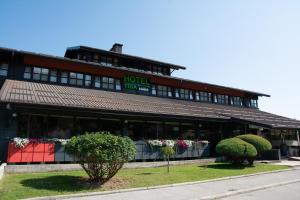 a hotel building with plants in front of it at Hotel TISA in Busovača