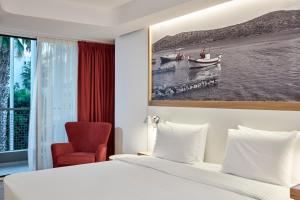 Postel nebo postele na pokoji v ubytování Olive Green Hotel
