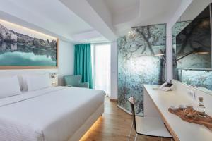 Postel nebo postele na pokoji v ubytování Olive Green Hotel